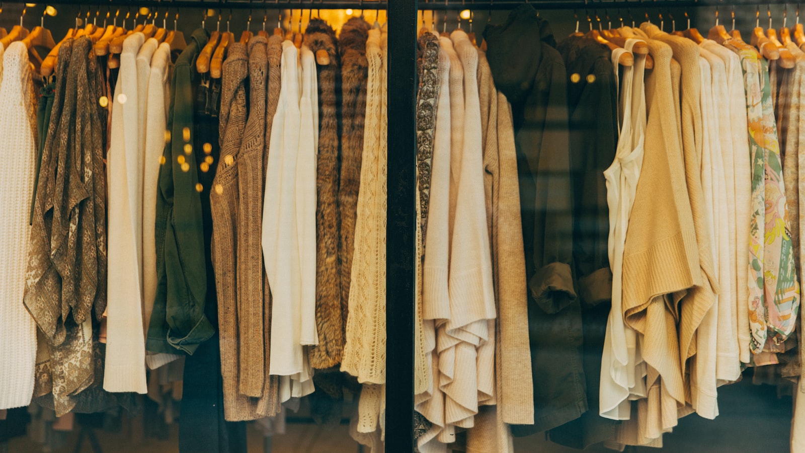 A rack of clothing in a range of colors, from neutrals to brights.