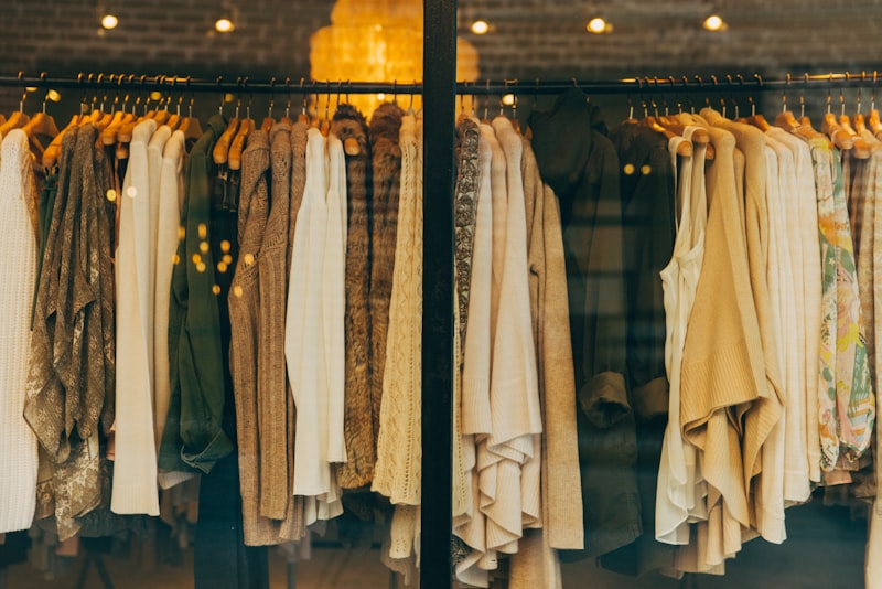 A rack of clothing in a range of colors, from neutrals to brights.
