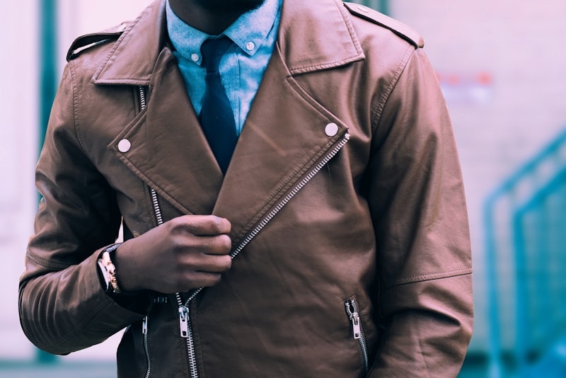 A person choosing clothes from a rail, looking relaxed and comfortable.