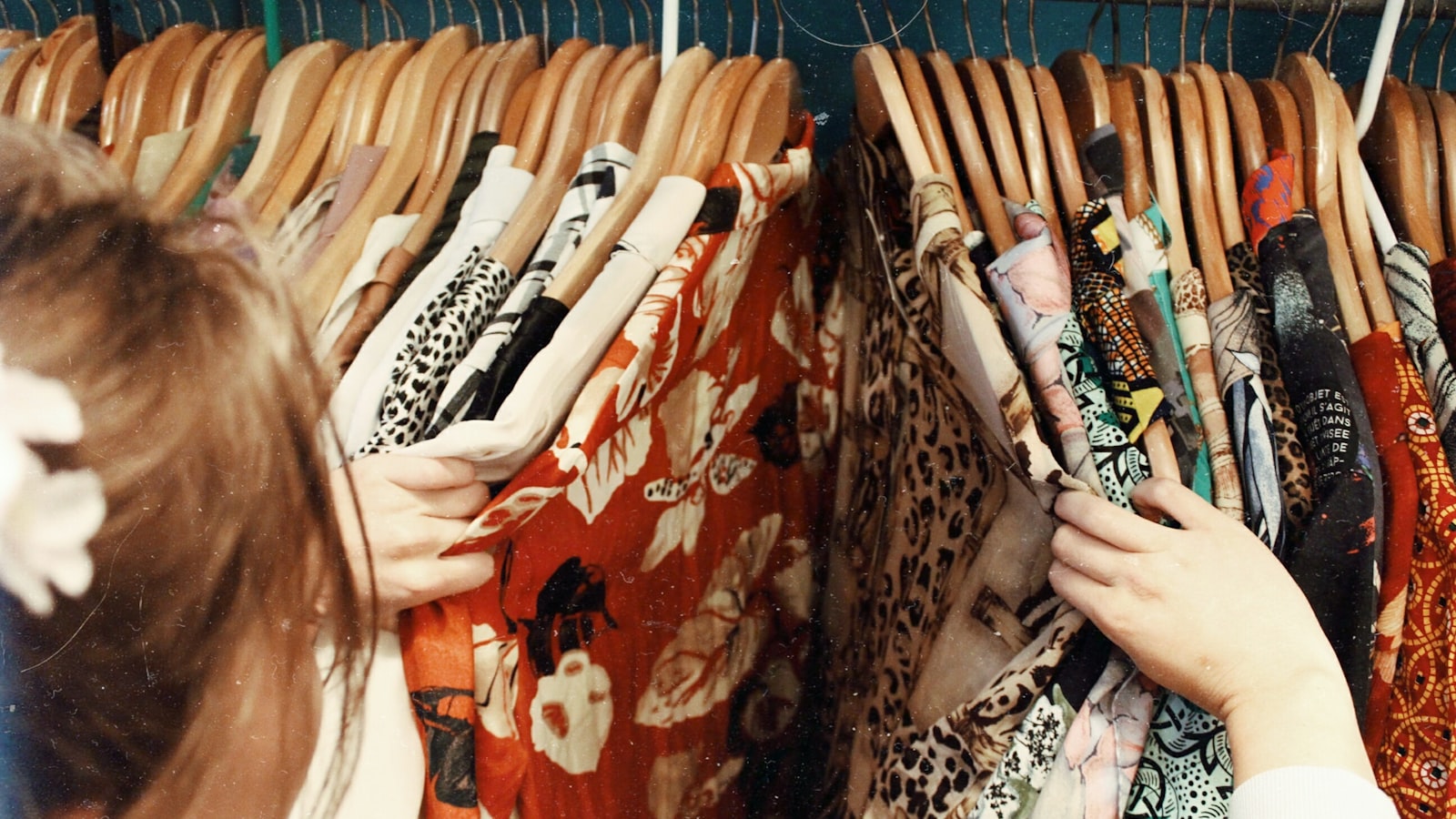Neatly pressed and folded clothes stacked on a surface.