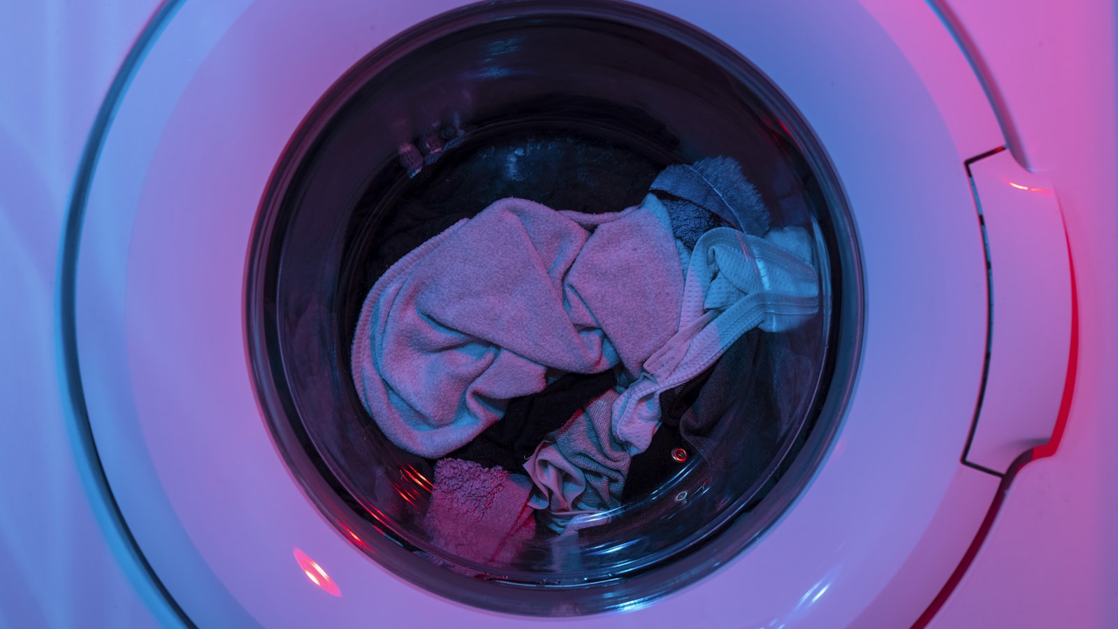 A washing machine and laundry supplies ready to treat and wash clothes.