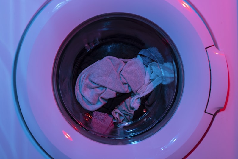 A washing machine and laundry supplies ready to treat and wash clothes.